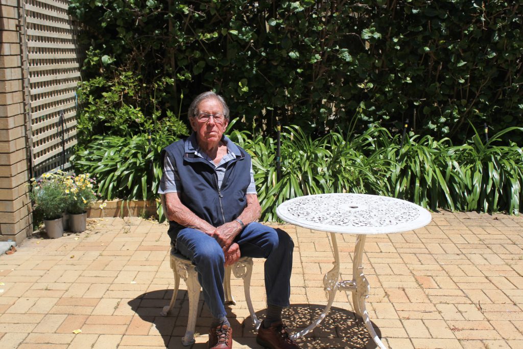 Doug Cedrick sitting in his garden