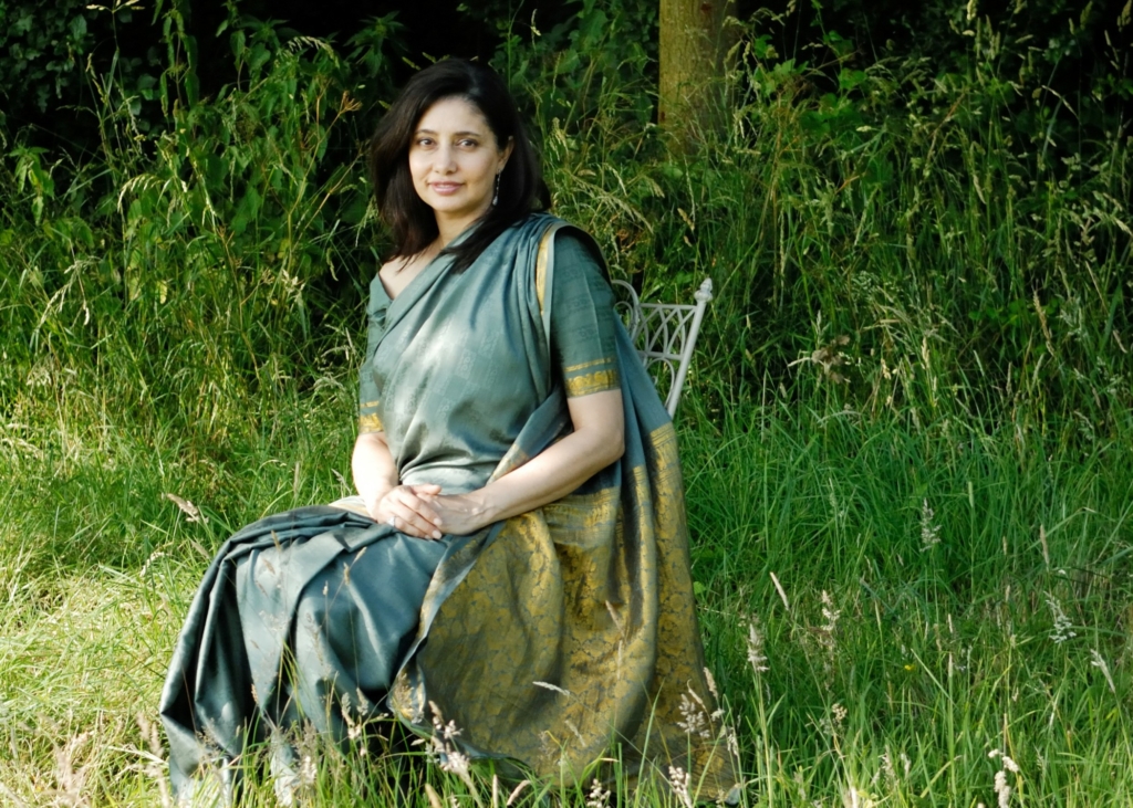 Photo of Kavita Jindal sitting on a chair in a grassy field