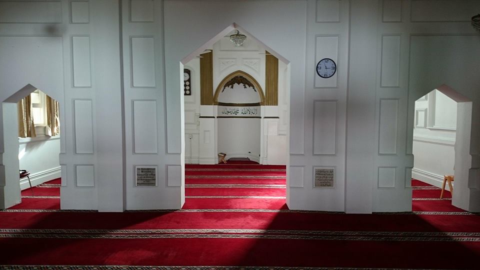 Perth Mosque: Inside. There is beautiful red carpet and delicate white arch ways. This is the prayer hall.
