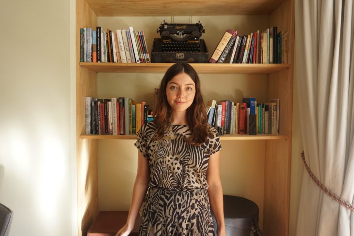Sophie Raynor, social media marketing and communications extraordinare stands before a book shelf at the Centre for Stories looking poised and lovely. She is wearing a cool zebra-esque dress that she wears only at the Centre as a funky form of self-expression that is not accepted in many corporate jobs which is a shame because it looks lovely.