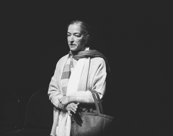 A black and white photo of amarjit performing for blue room theatre
