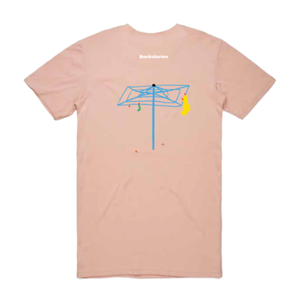 A photograph of a pale pink t-shirt. On the back of the shirt is a really cool illustration of a bright blue hills hoist with some washing on it. Above that, the iconic Backstories logo in white.