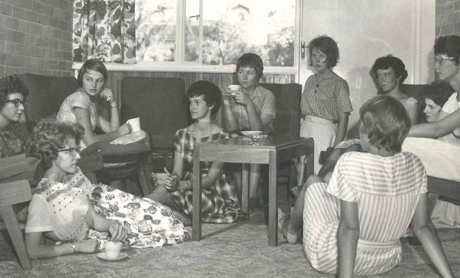 Black and white photograph of a group of women sitting in a lounge room